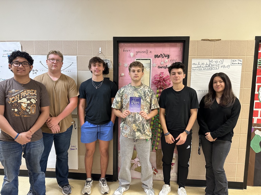 students posing with flyer