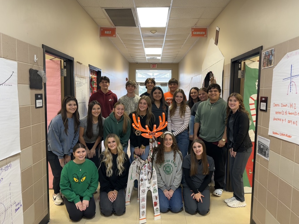 students posing with reindeer