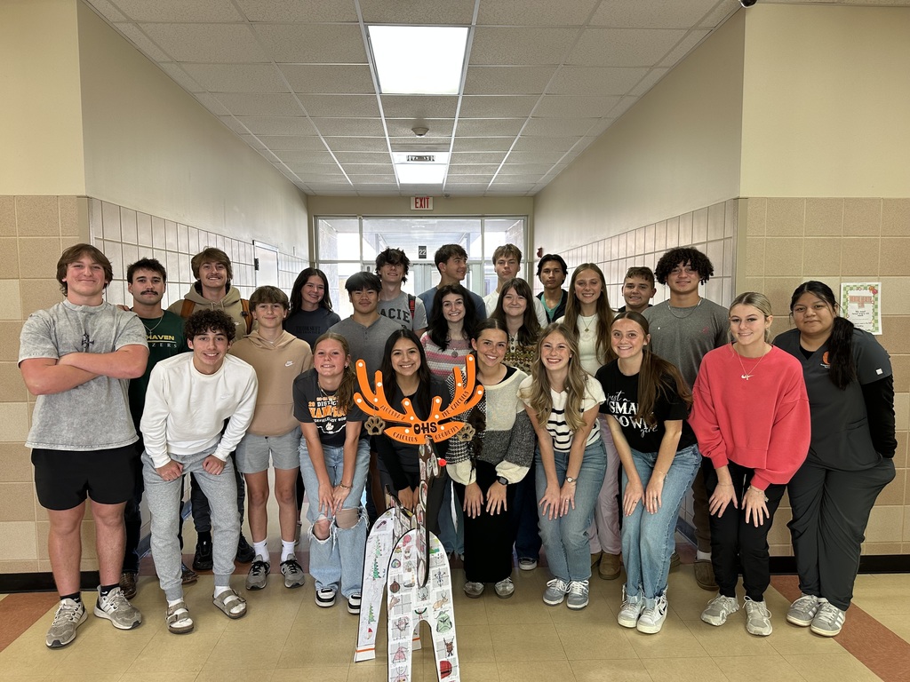 students posing with reindeer