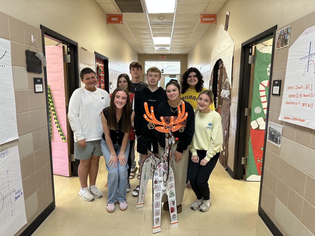 students posing with reindeer