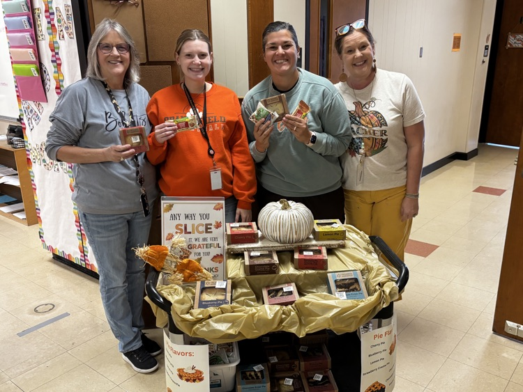 OJH Staff pose for a picture in front of the jolly trolly with their pies.