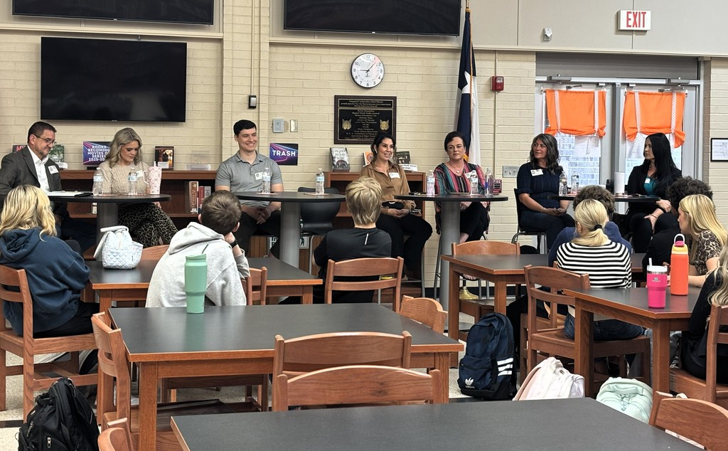 student sitting at library tables listening to guest speakers