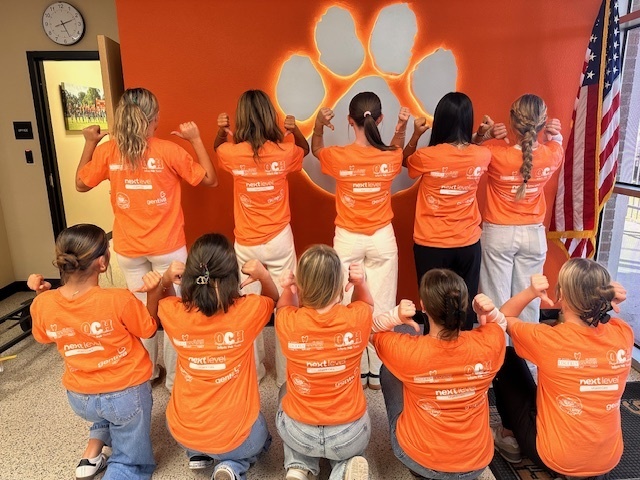 students wearing orange and white HOSA shirts-back