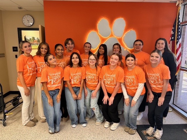 students wearing orange and white HOSA shirts-front