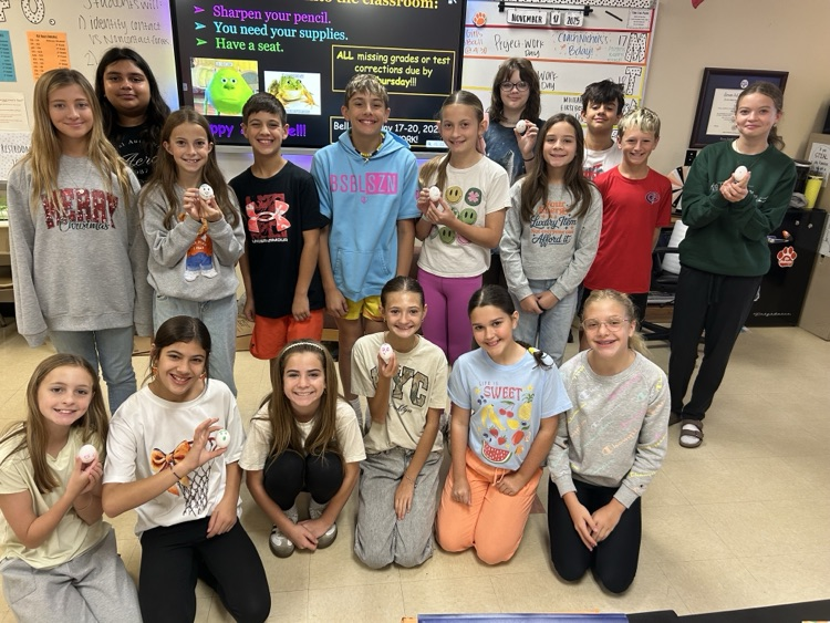 students posing with their egg contraptions.