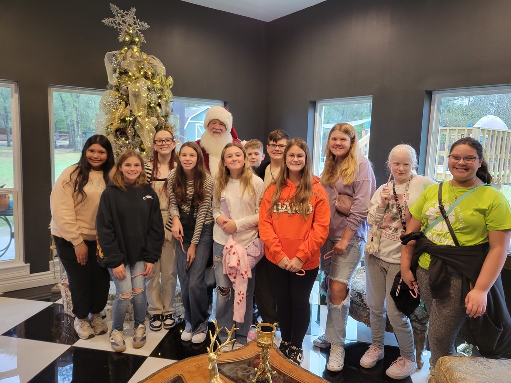 Stuco and NJHS pose for a photo with santa at Toy Coffee.