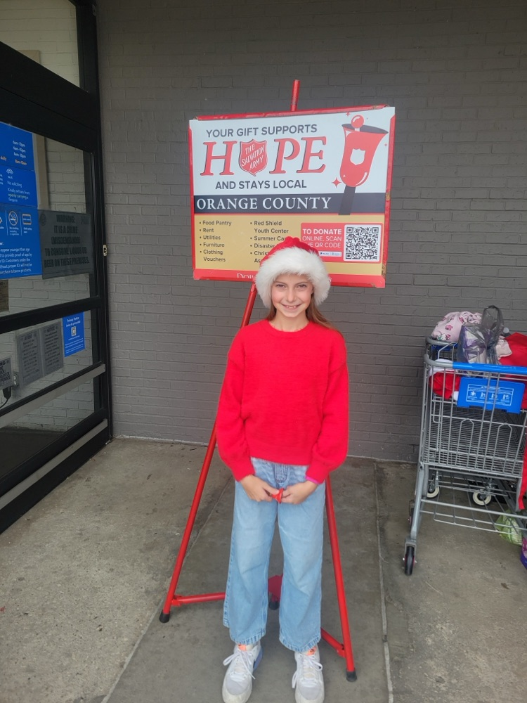 An OJH STUCO member poses for a picture while ringing bells for the Salvation Army.