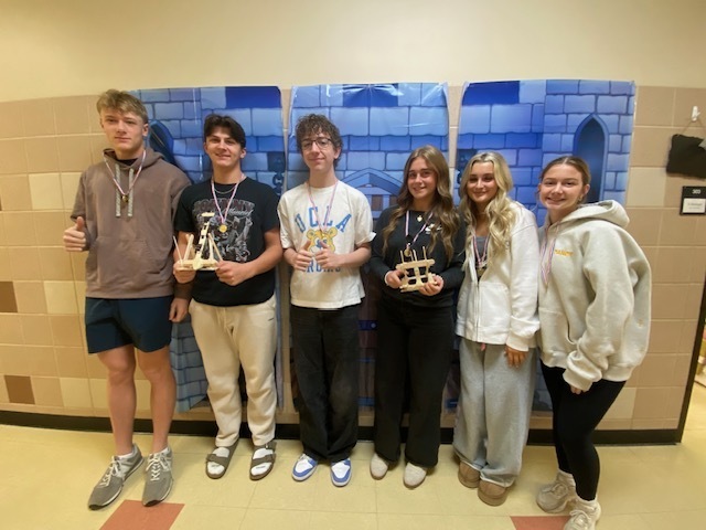 six students with medals