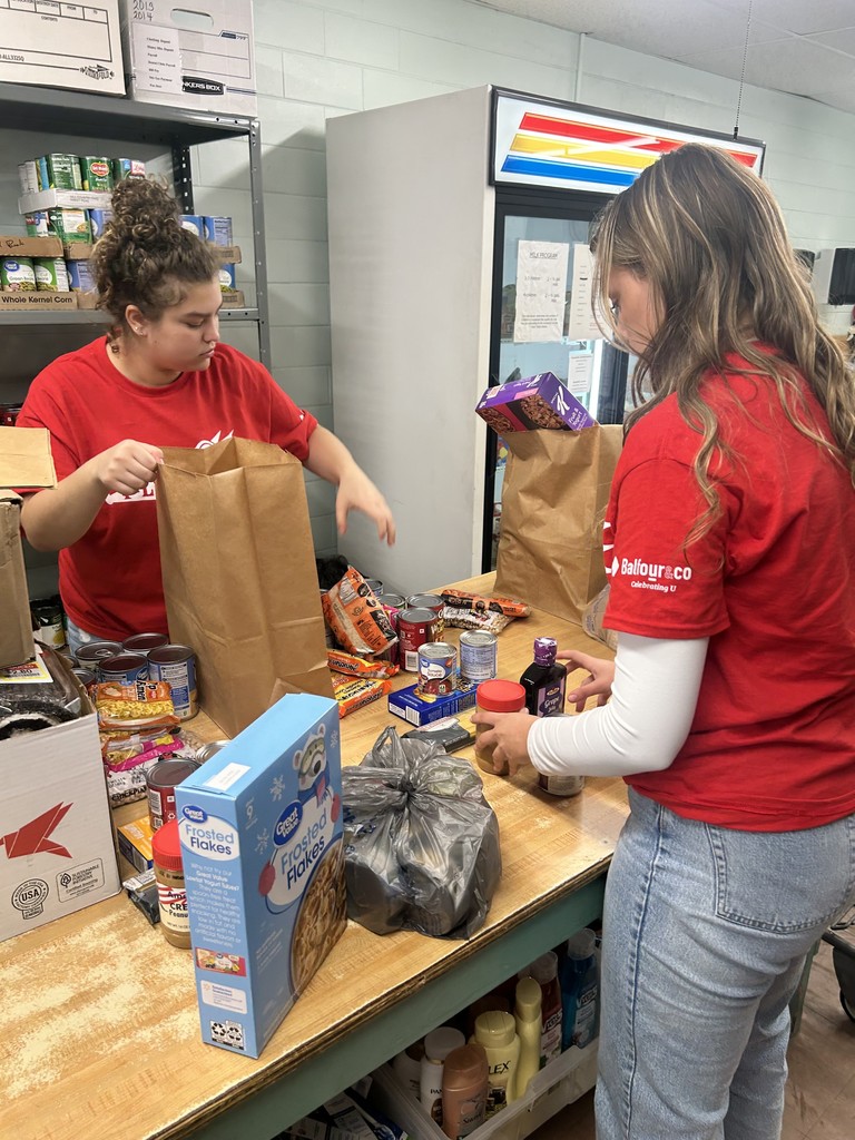 two students sorting groceries