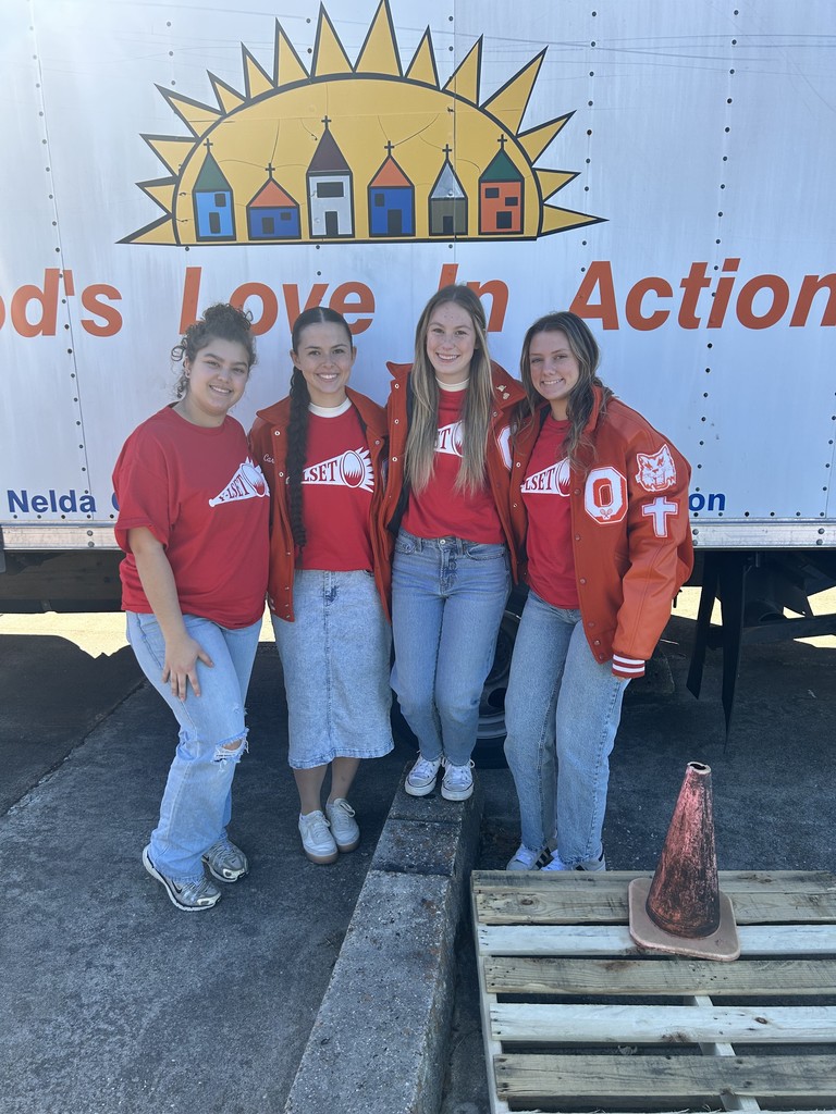 four students in front of delivery truck