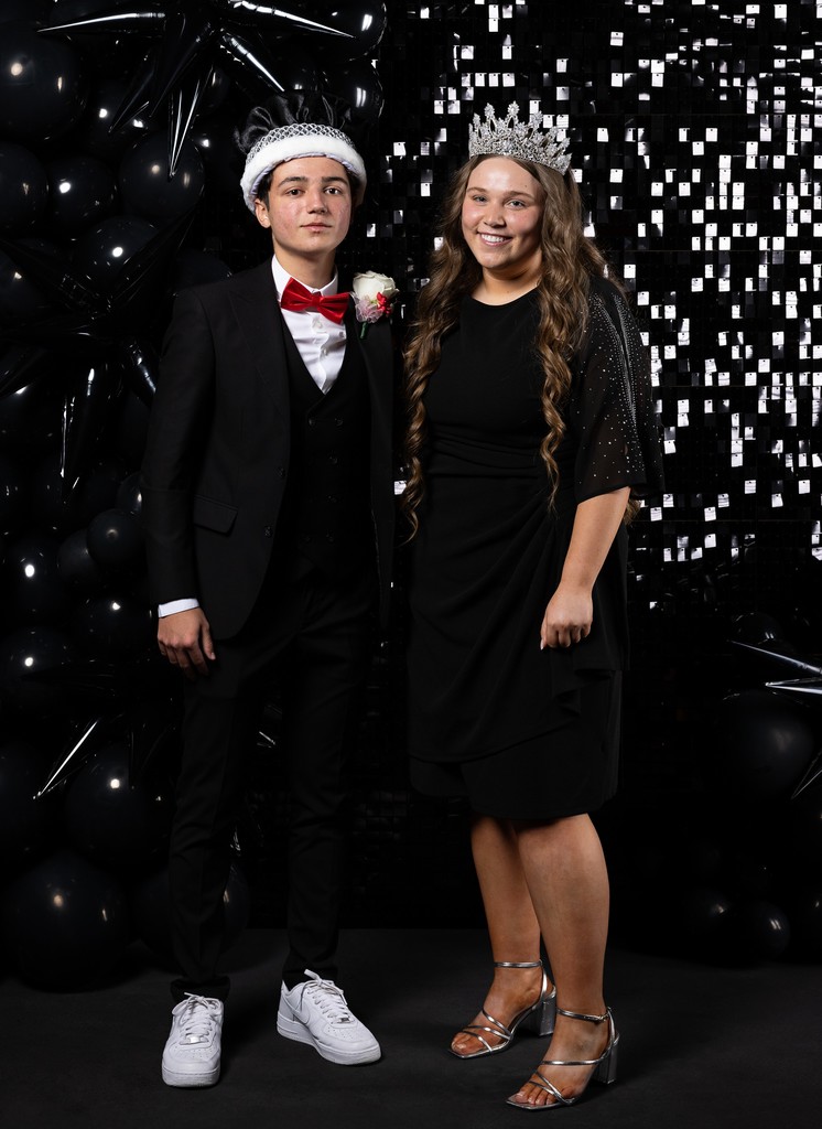student in tux with crown and student with black dress and crown