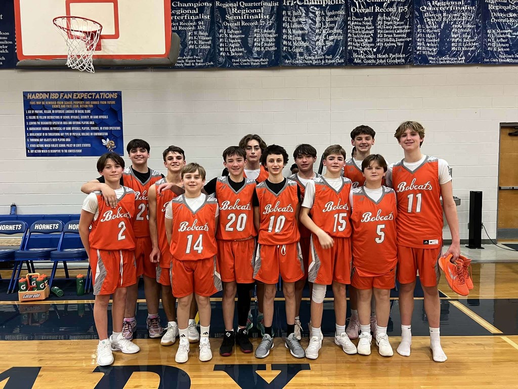 8th grade boys basketball team pose for a group picture.