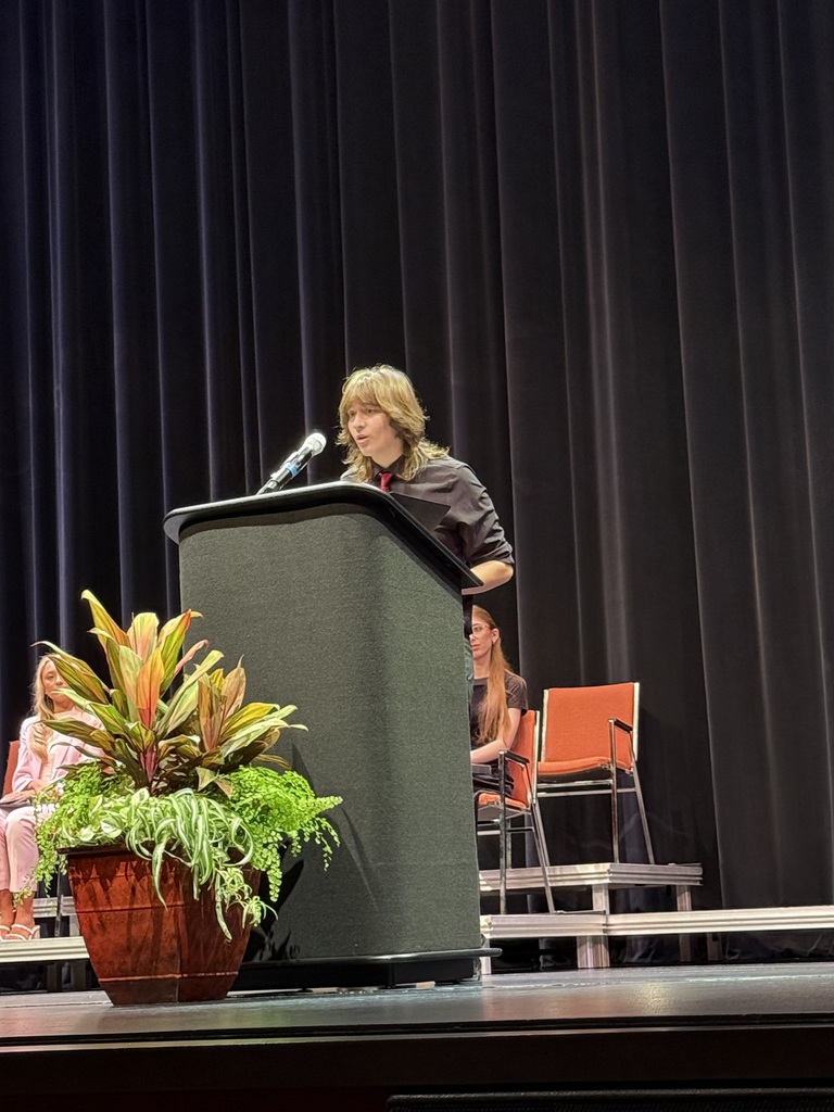 speaker on stage at a podium