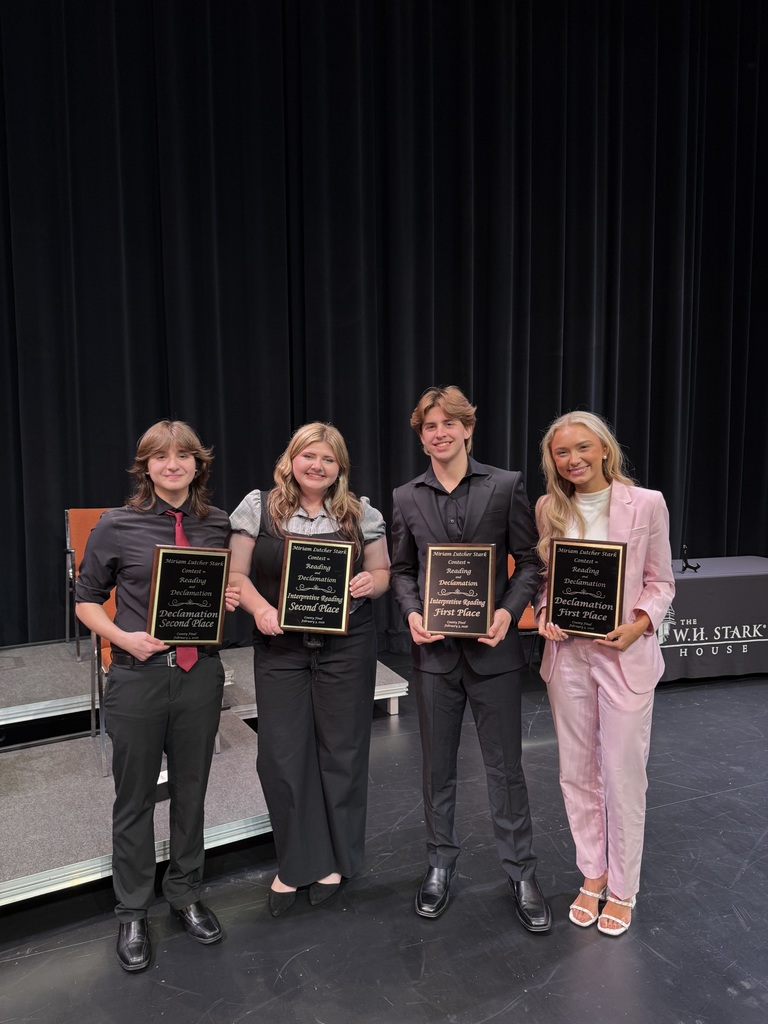 four students with plaques
