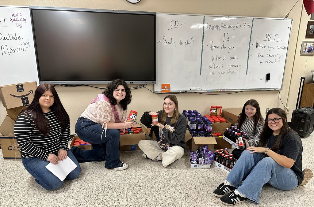 five students with donated peanut butter and jelly jars