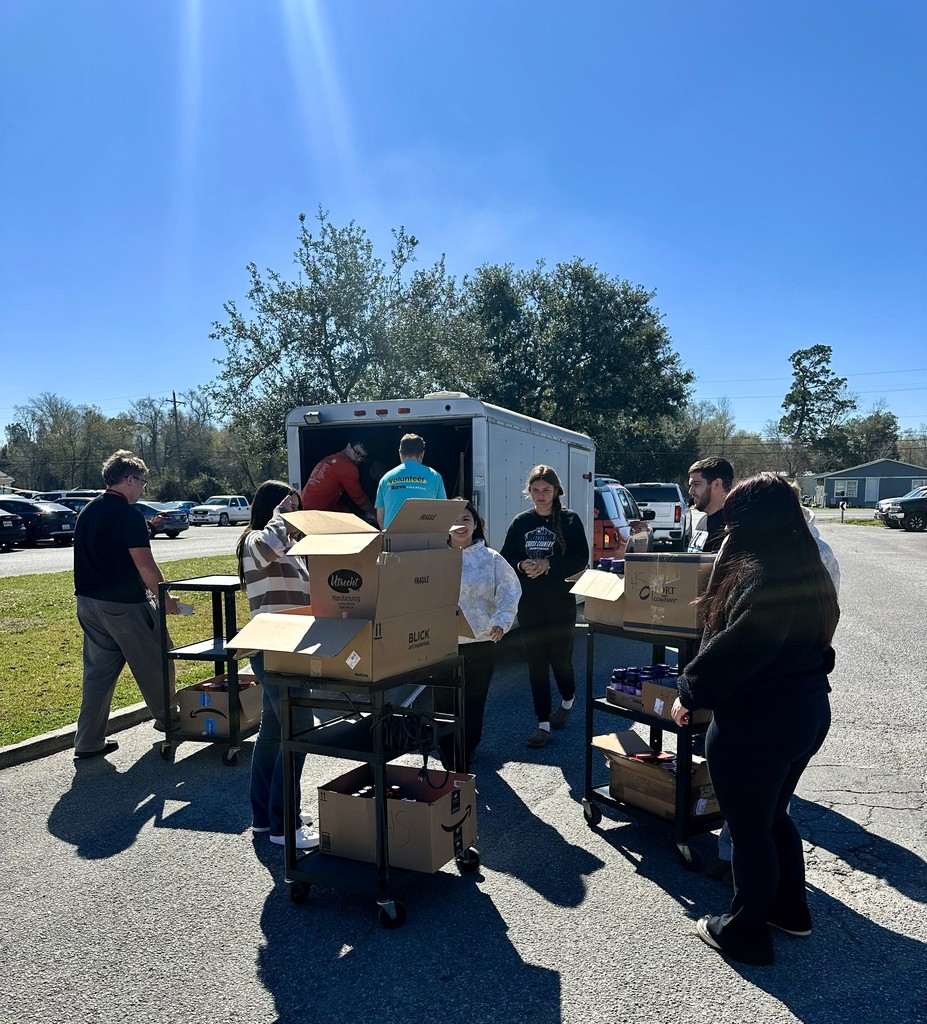 students loading donation boxes into trailer