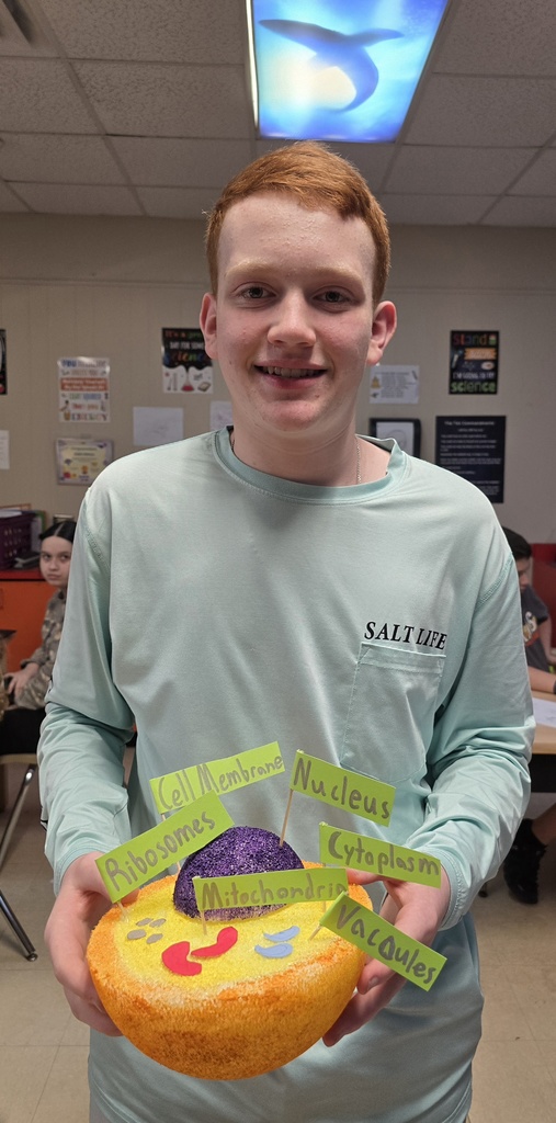 8th grade student posing with their science project.