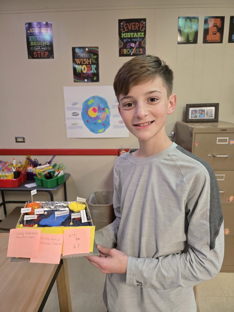 8th grade student posing with their science project.