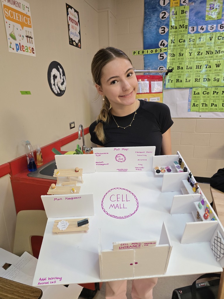 8th grade student posing with their science project.