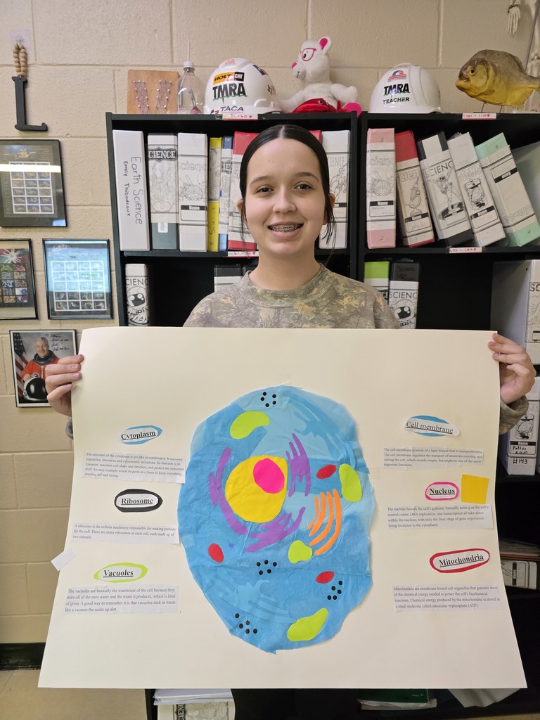 8th grade student posing with their science project.