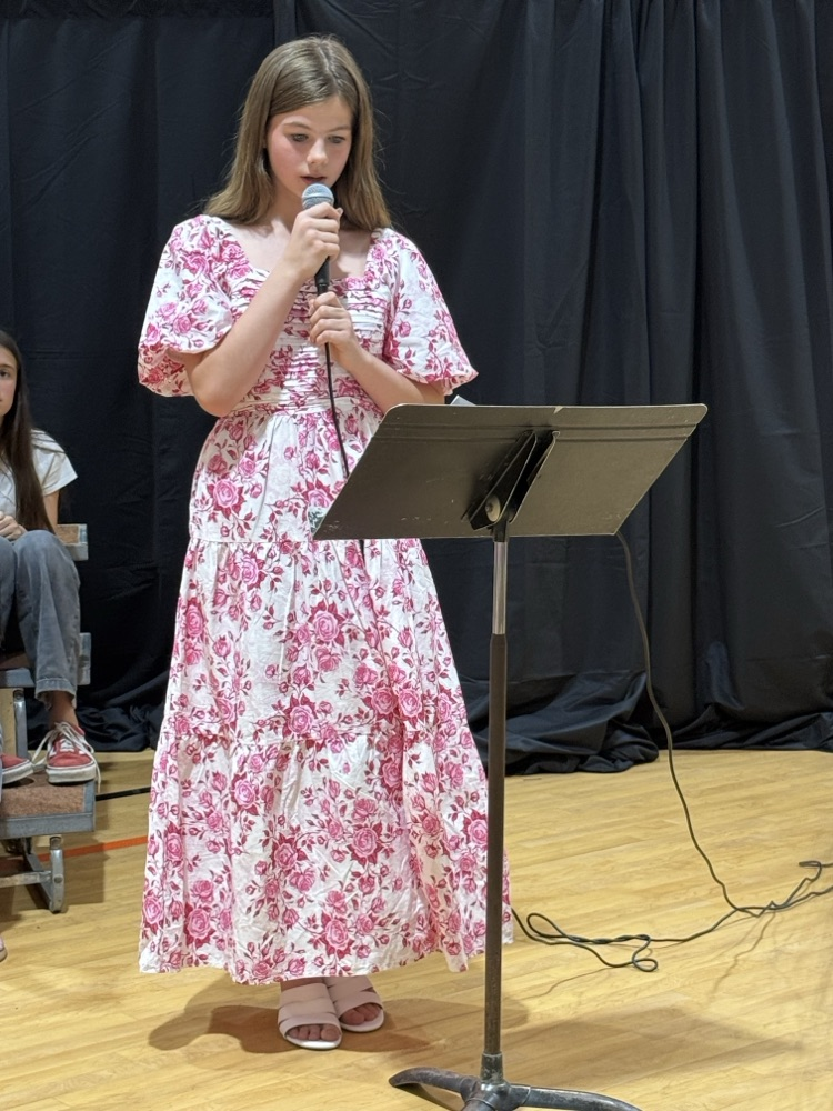 A choir student is photographed singing .