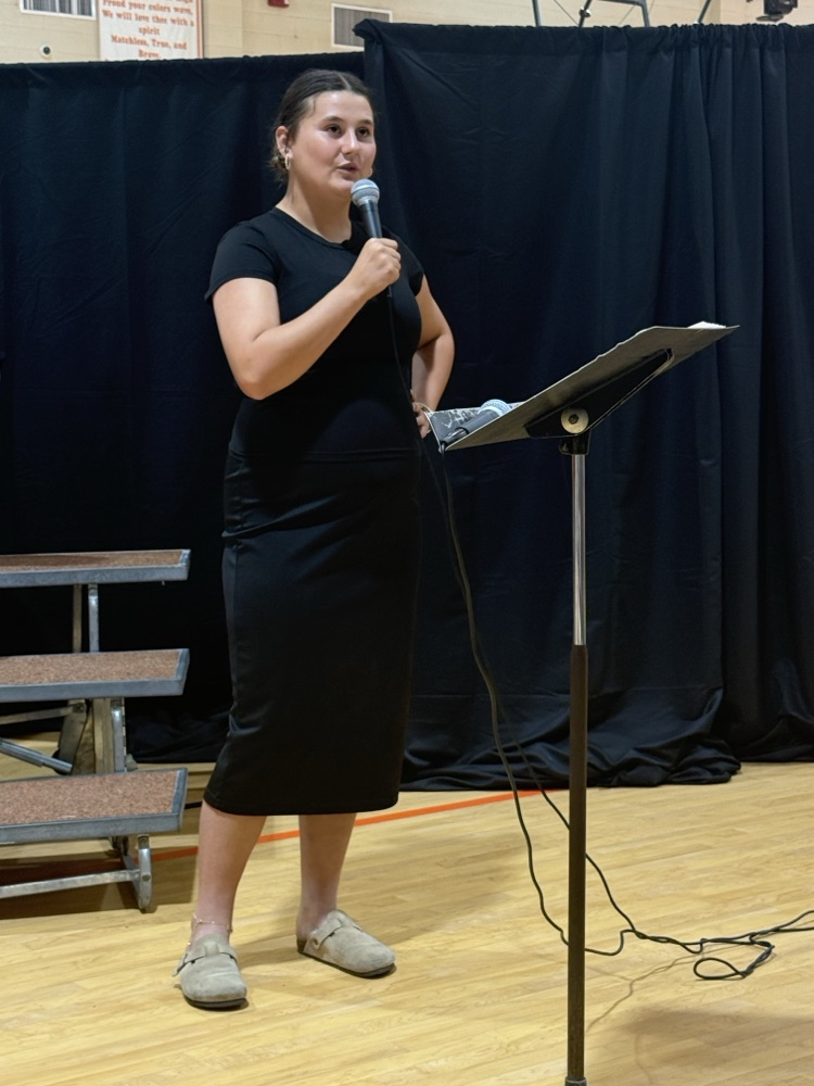 A choir student is photographer singing.