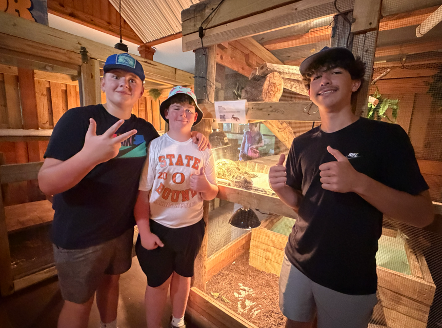 8th graders pose for a picture with a reptile.