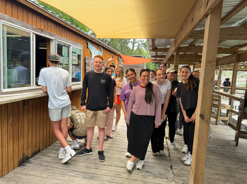 8th graders wait in line at the concession stand to get snow cones.