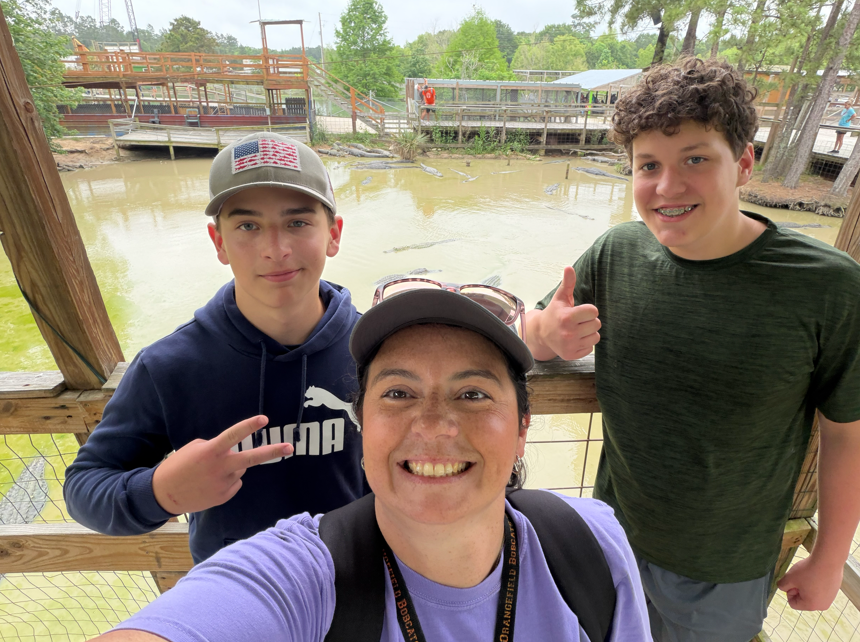 Mrs. Broussard and two 8th graders pose for a picture.