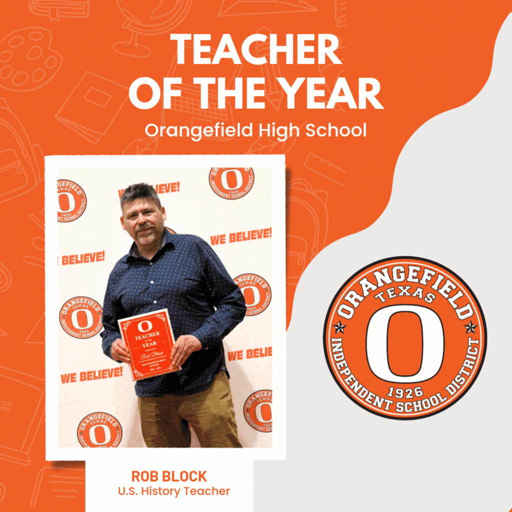 An adult male holds a red award in front of a school logo and banner.
