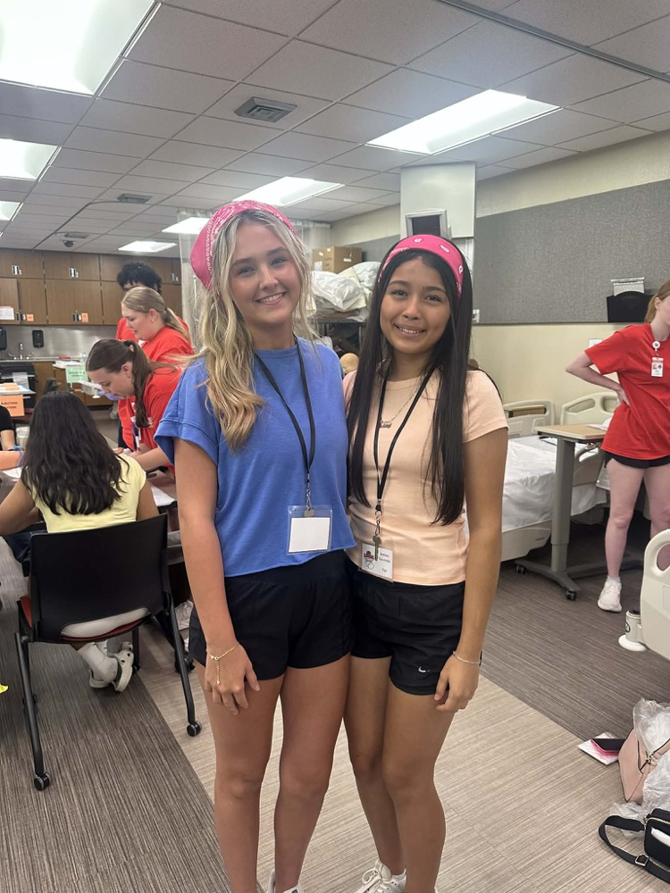 two students in t-shirts and black shorts