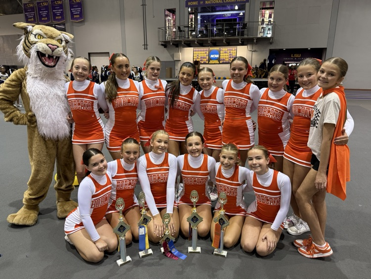 OJH Cheer Team pose for a group photo with their awards.