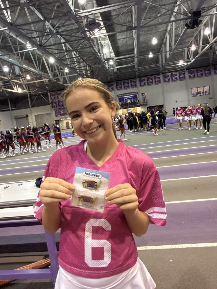 An OJH cheerleader poses with her reward.