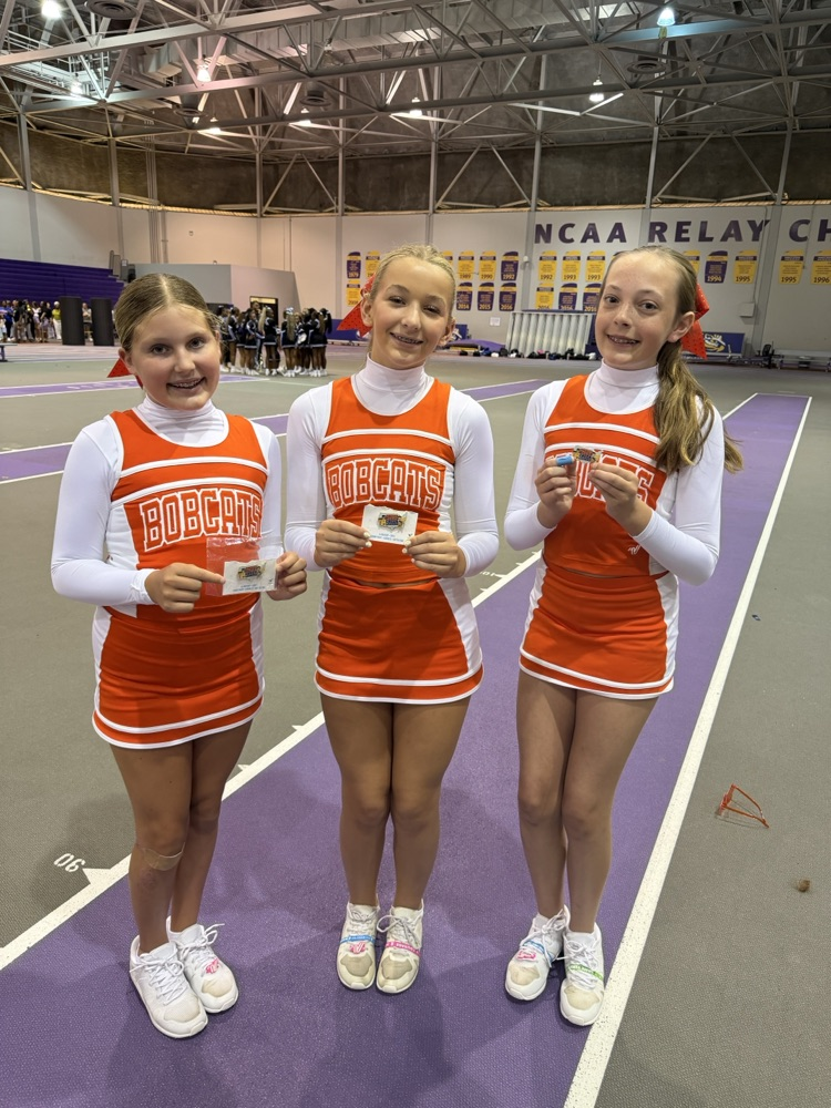 OJH Cheer Team pose for a group photo with their awards.