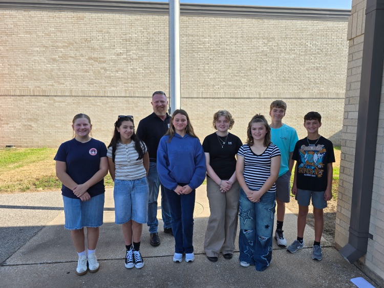 Students pose for a picture with Mr. Richard Teague.