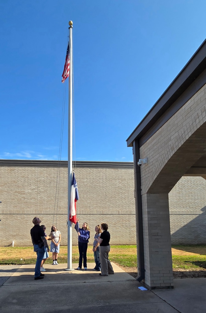 Mr. Teague showing the students how to raise/lower the flag.