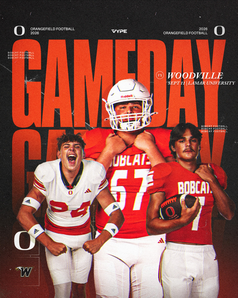 Three football players pose. Two wear red jerseys, one white. One holds a ball, one smiles. Background is blurred.