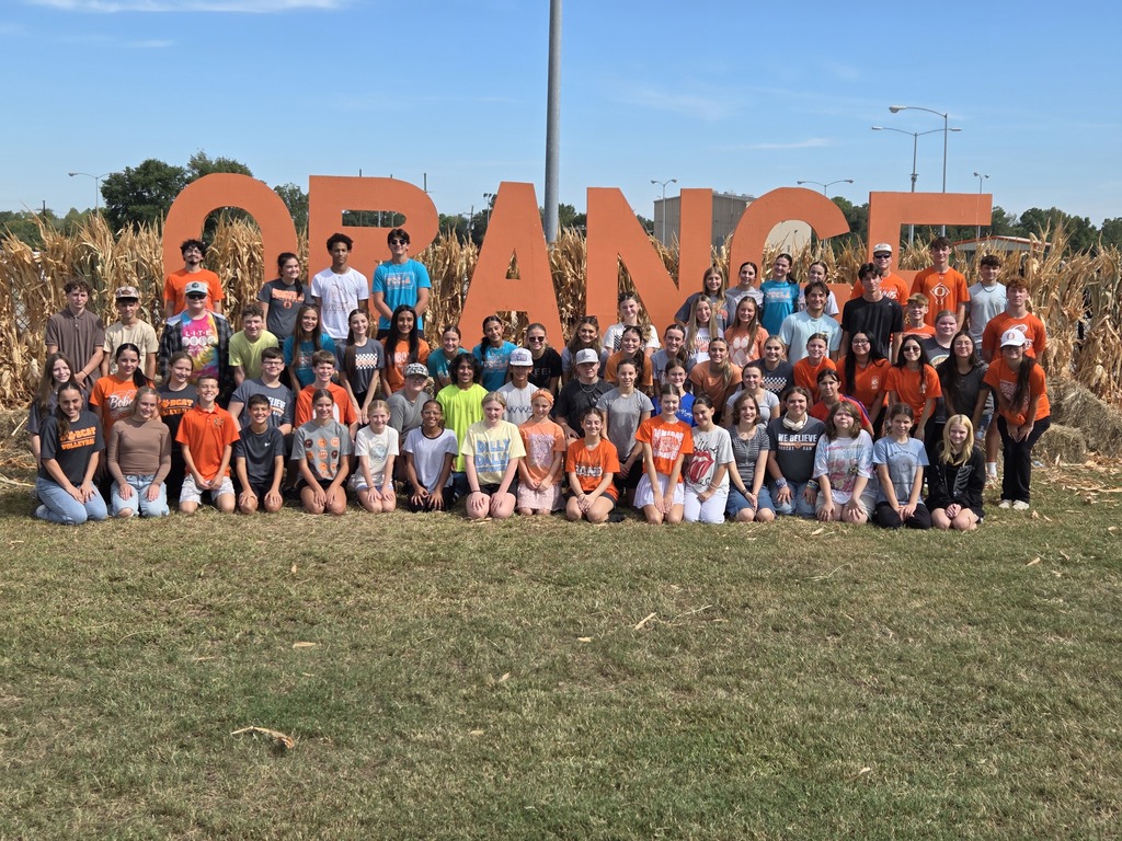Students posing at the set up for orangetober fest.