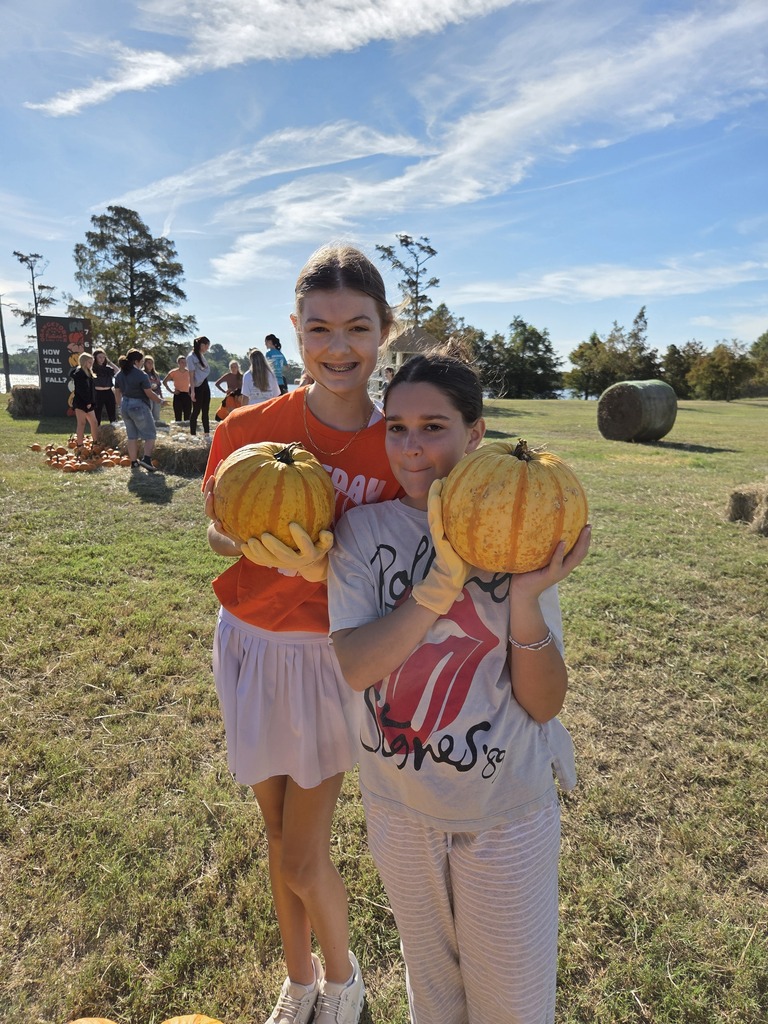 Students setting up pumpkins for orangetober fest.