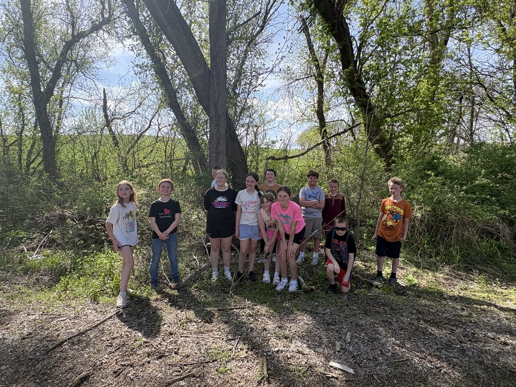 4th & 5th grade students in a group with trees in the background