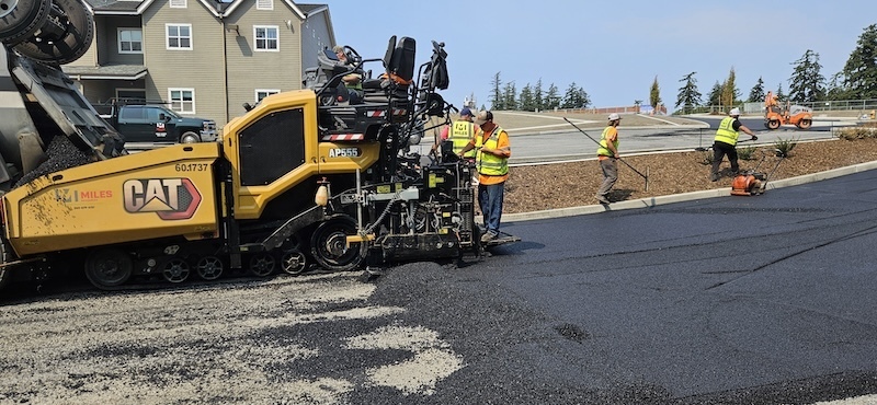 Construction vehicle with new asphalt