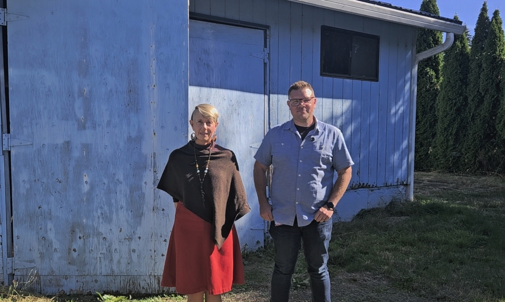 CTE staff standing in front of blue building that will be transformed by grant funding