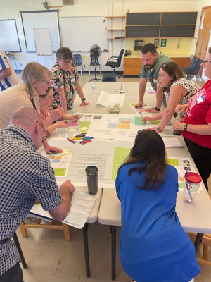 Design Advisory Committee huddled around a table.