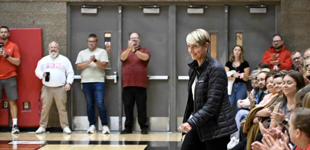 Angie walking from the crowd to the staff handing out awards