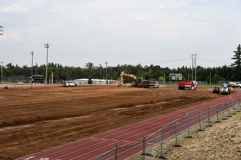 Construction Trucks removing natural turf on OCHS field.