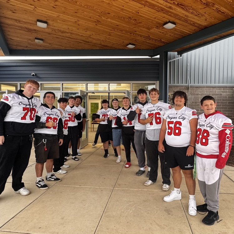 football players welcome students to school 