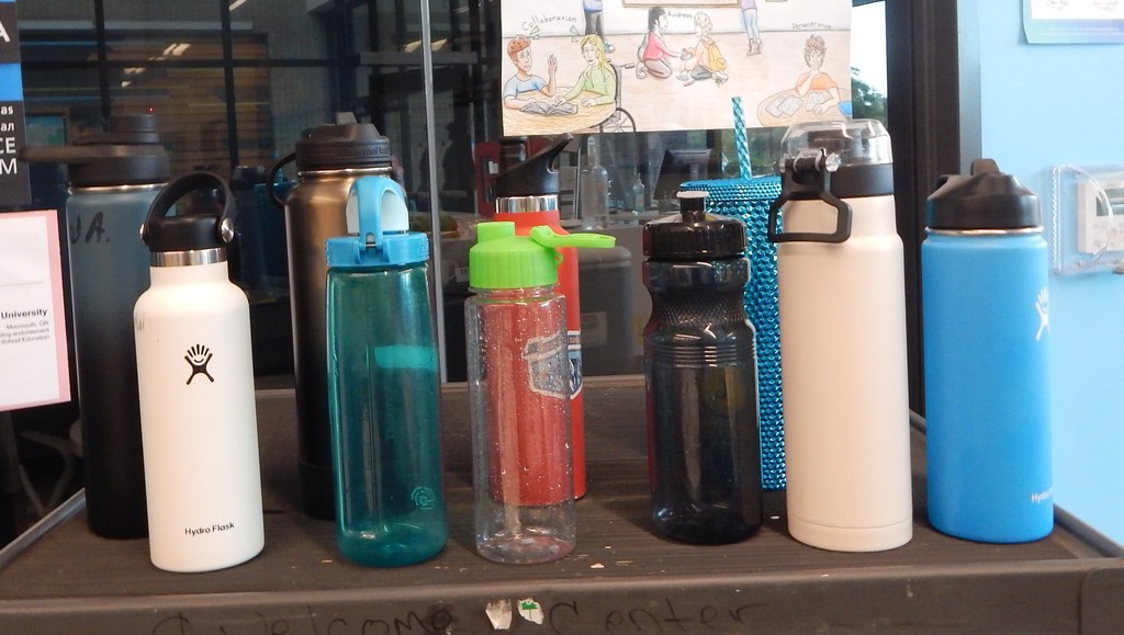 Various water bottles sitting on a cart.