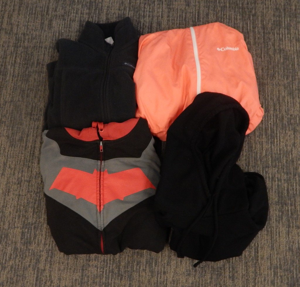 Four jackets - 1 peach windbreaker, 1 black/grey sweatshirt with red bat, 2 black
