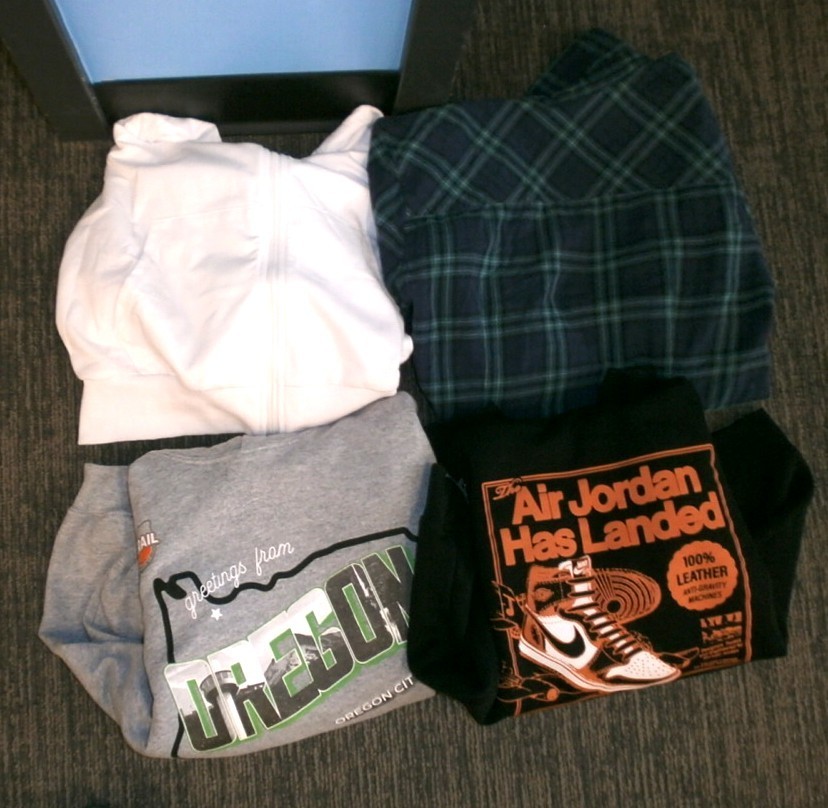 black/orange Air Jordan sweatshirt, grey Oregon sweatshirt, white hoodie, blue/green plaid robe