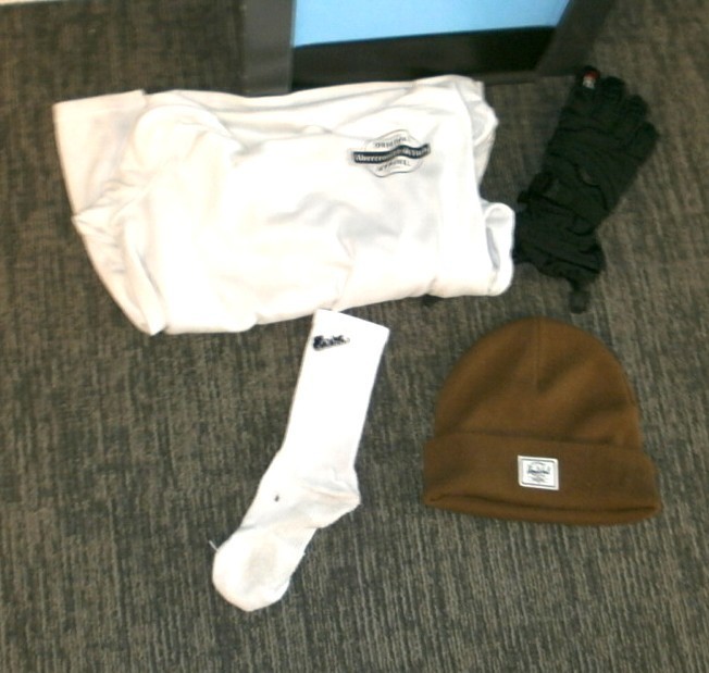 Brown beanie, lone sock, white shirt, black glove